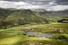 Green Mountains with spots of sunlight in the Mahloti Mountains, Eastern Cape Province, South Africa.