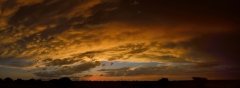 Wide panorama of vivid cloud details at sunset.