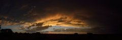 Cloud details lit up by the setting sun very wide panorama.