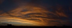 Cloud details of a red/orange sunset , wide panorama.